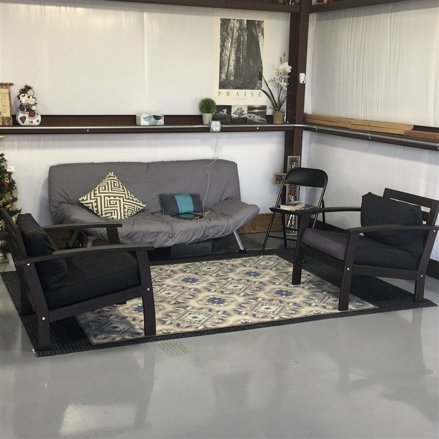 A spacious and inviting parent's lounge with comfortable chairs, kid's books and coloring materials, Wi-Fi, magazines, and bottled water service. This lounge provides a comfortable waiting area for clients, making it a welcoming space for parents and children in Benbrook.